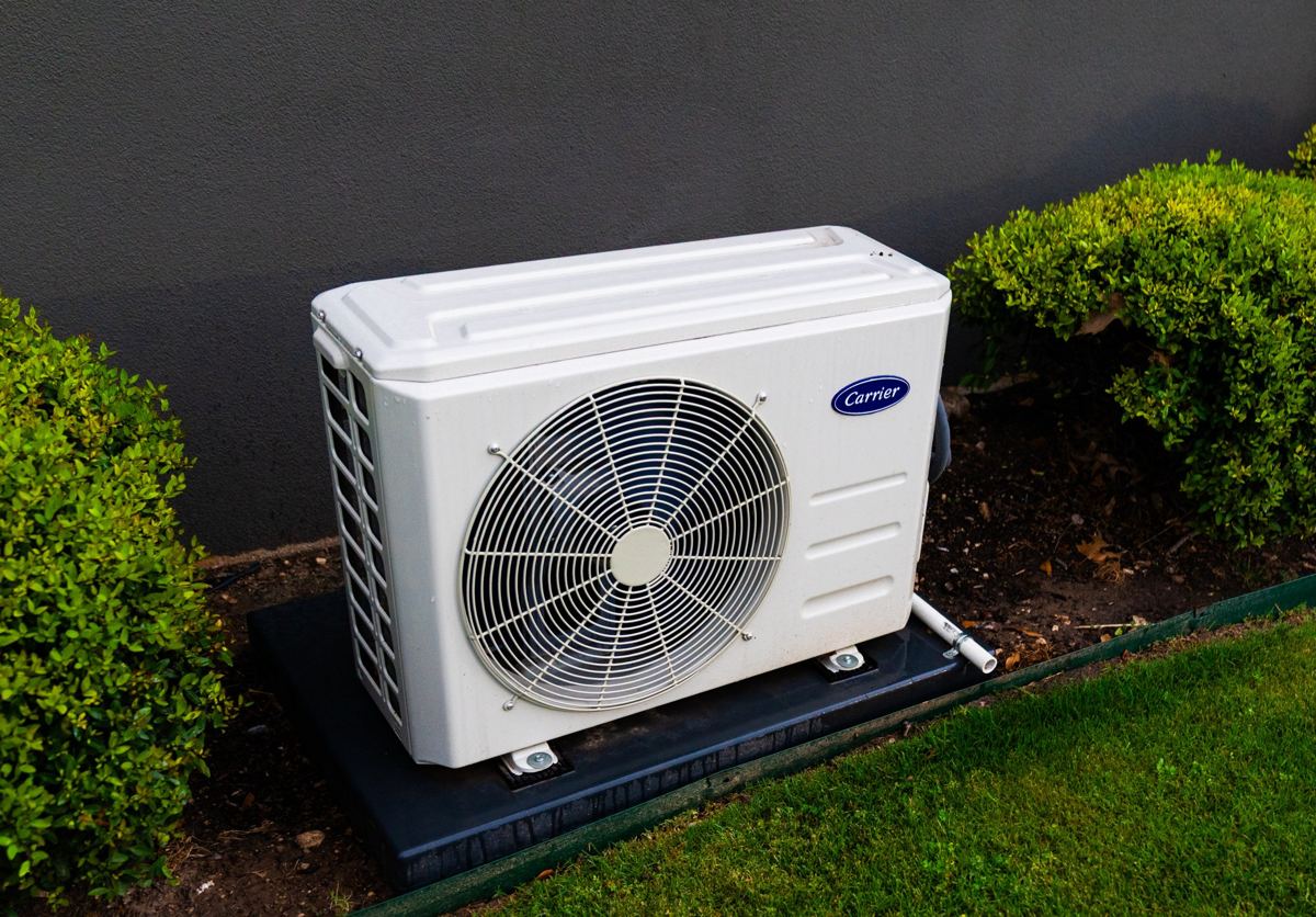 Carrier ductless heat pump outdoor unit on a pad