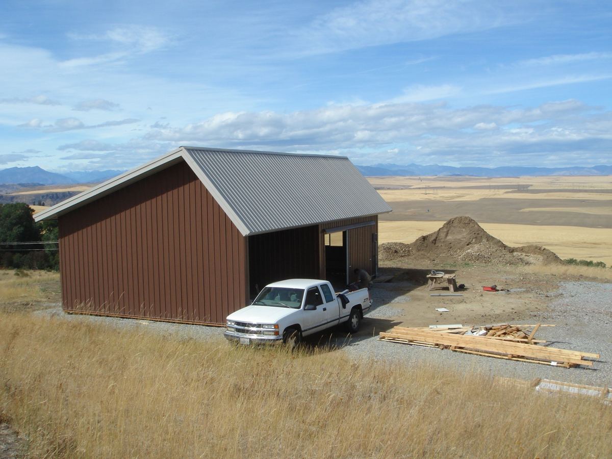 Metal-sided pole barn with a pickup truck